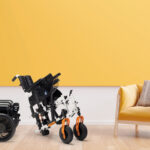 Living room interior with yellow fabric armchair,book and plants on empty yellow wall background.3d rendering